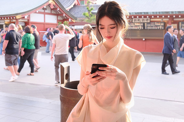 Woman wearing a light-colored blouse in a busy outdoor setting