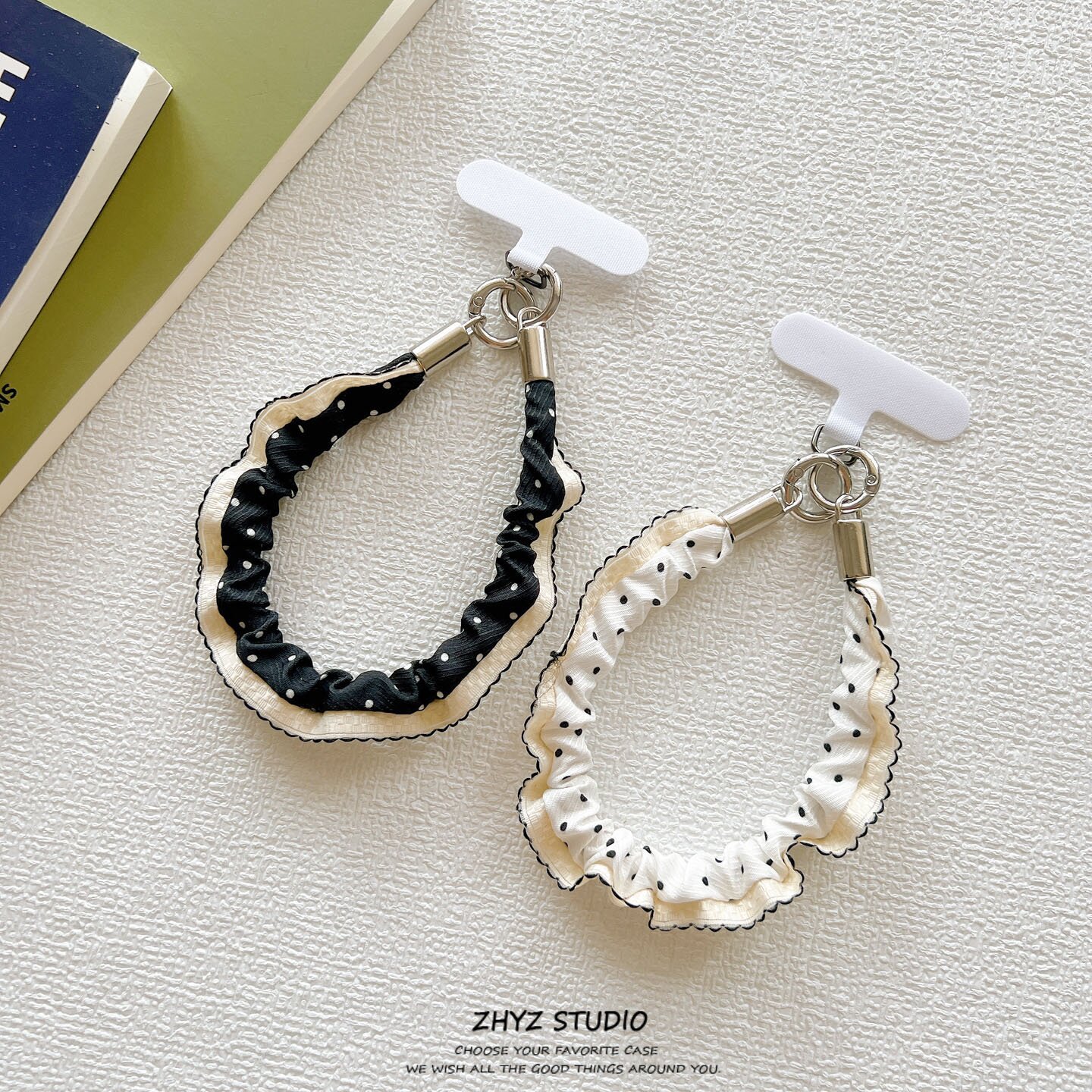 Premium-looking phone case lanyard with black and white polka dots and pleated details, short rope wrist strap, hand chain, keychain, charm
