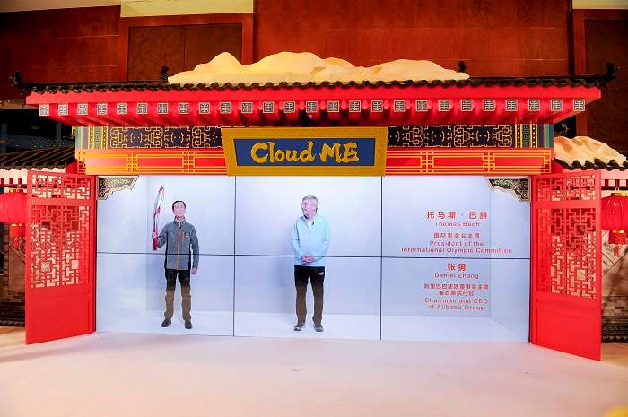 Photo 2: Daniel Zhang in Shanghai Cloud ME studio (left), with Thomas Bach from Beijing closed-loop (right), having a true-to-life meeting projected at the Beijing Media Center