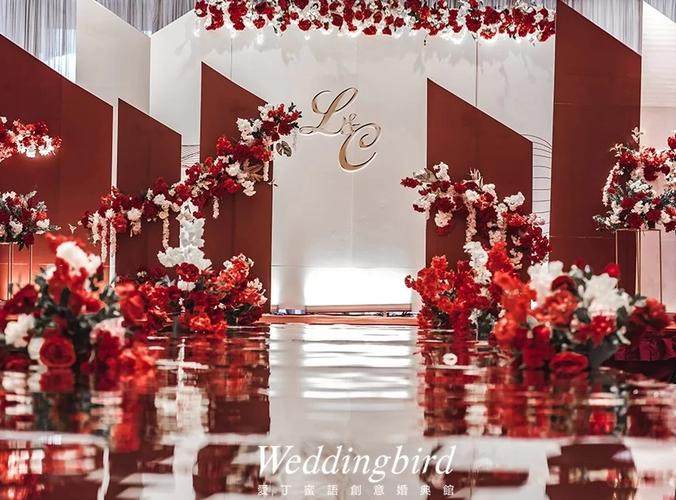 Romantic wedding table with burgundy and blush flowers and gold accents in an intimate reception setting