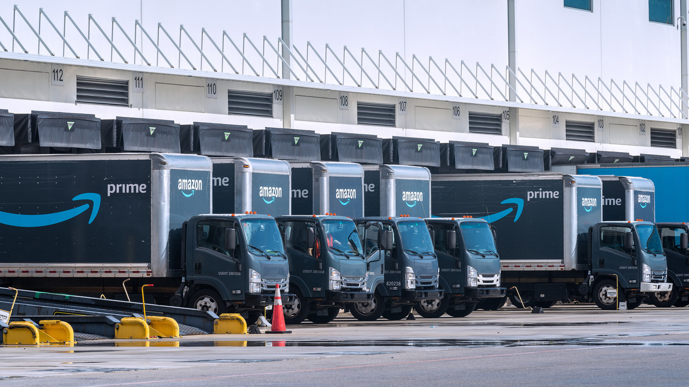 Amazon delivery trucks at a warehouse