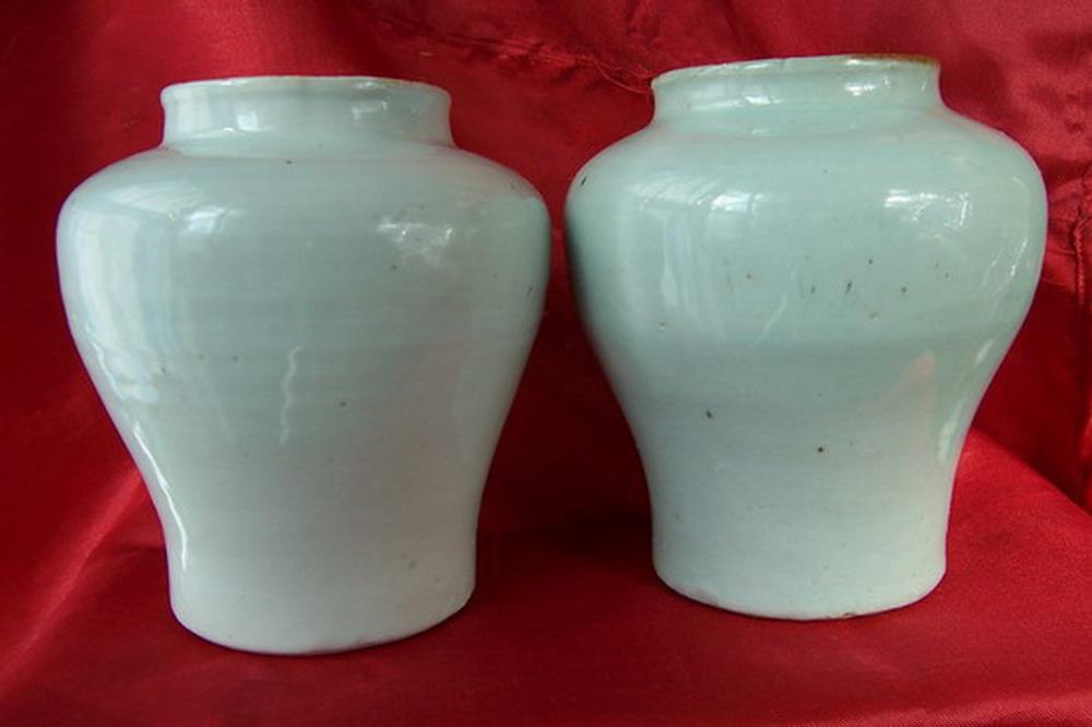 A pair of white glaze cans