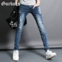 Quần jeans nam mùa thu Gurbaks phiên bản Hàn Quốc của quần thời trang Slim quần nam có lỗ thun nam quần jeans nam