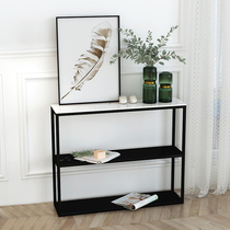 Modern minimalist iron and art rack leaning against wall narrow table double bookshelves with narrow strips a few sofas behind closed shelves