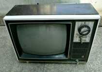 Old - fashioned wooden - cash gold - black - and - white TV