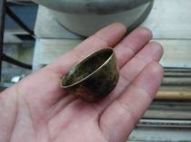 A small cup of clear brass in clear brass