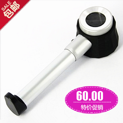 Hand holding 30 times 60 times the magnifying mirror with scale maintenance to identify jewelry jade antique silver