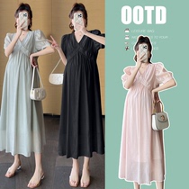 Pregnant womans summer clothing dress with a long loot in her dress and a pregnant womans maternity dress dress