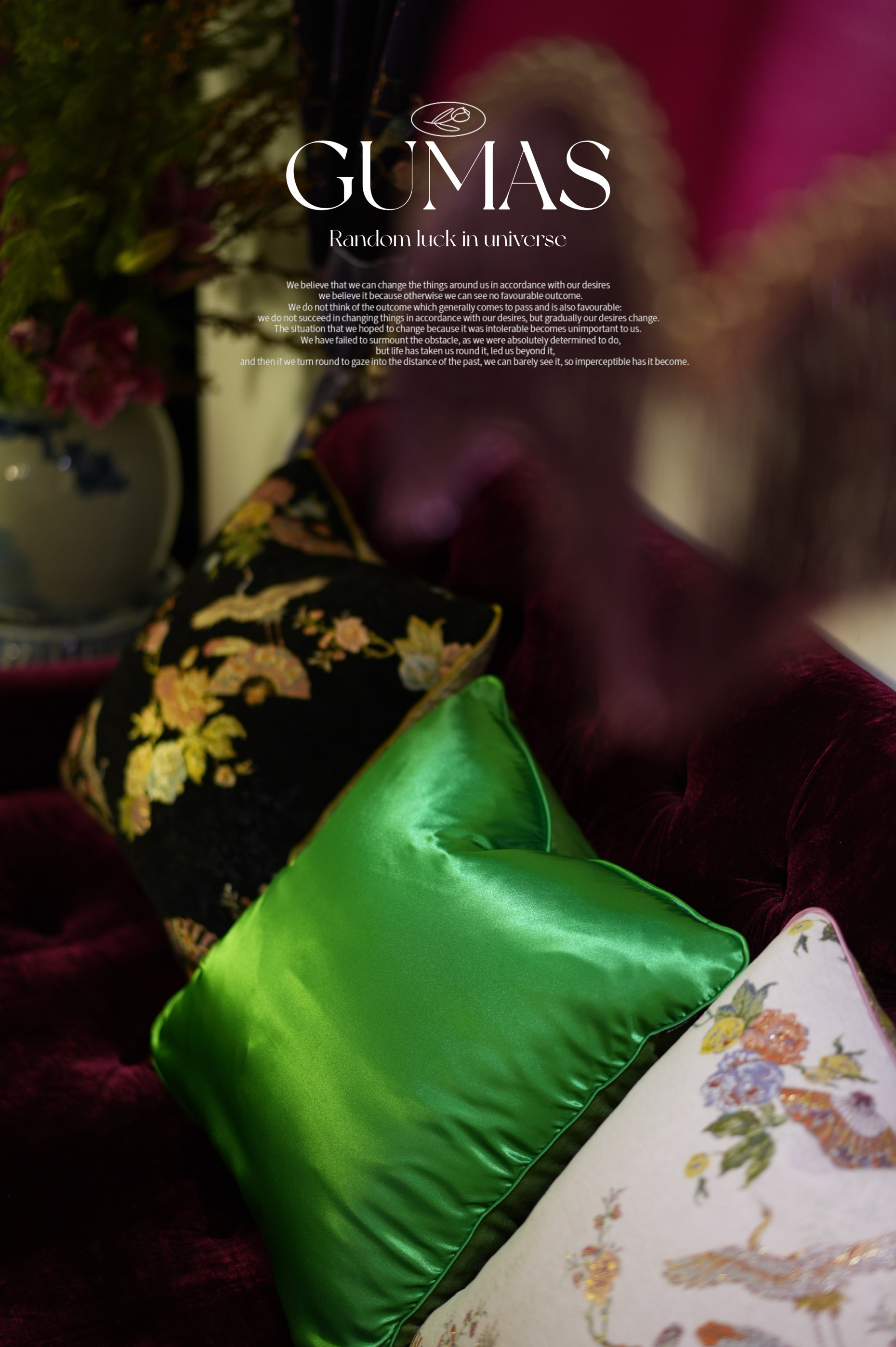 Lime green embroidered pillow styled with burgundy velvet sofa and botanical print accent cushions