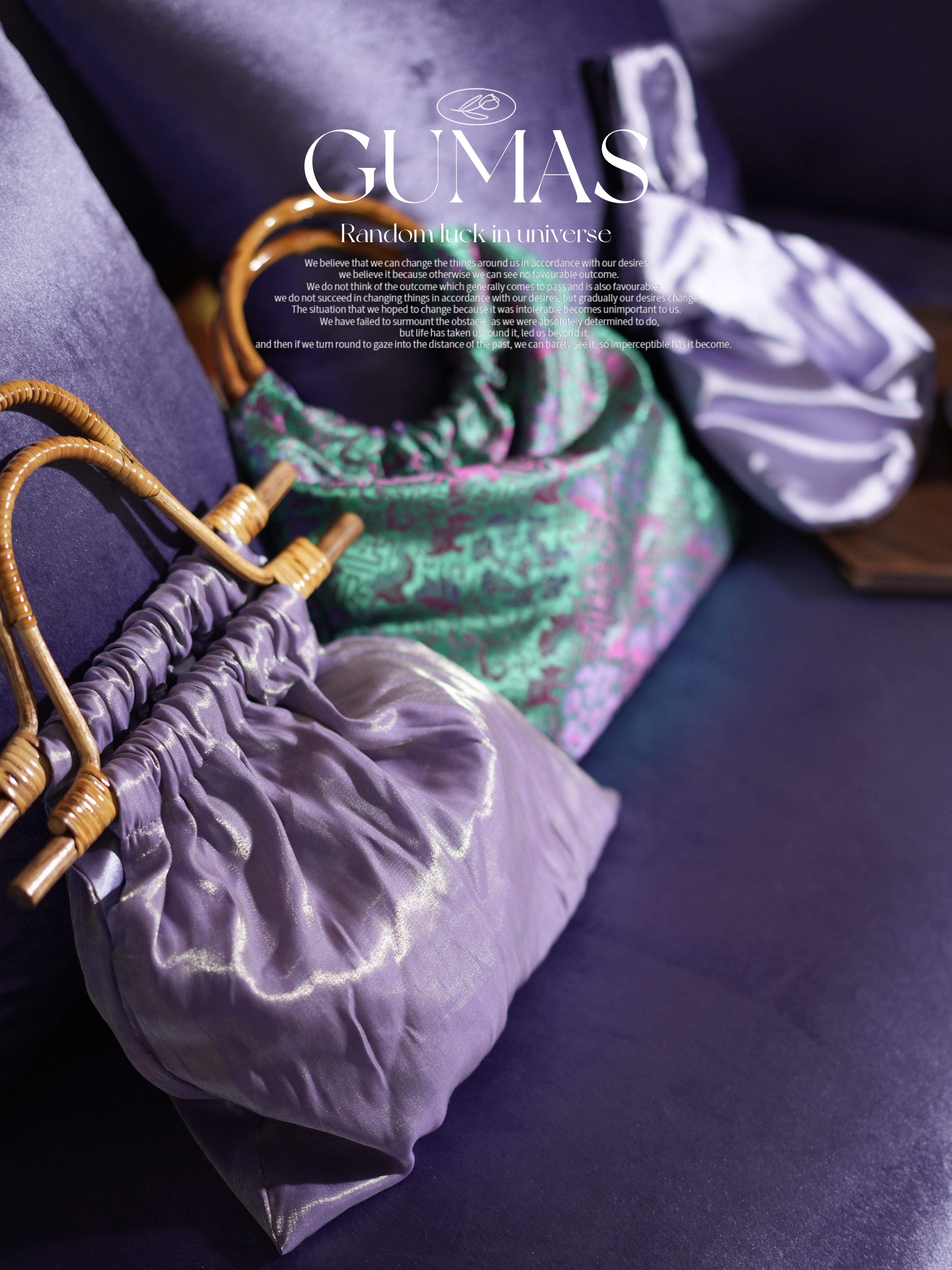 Side view of purple metallic handbag showing dimensional gathered fabric design
