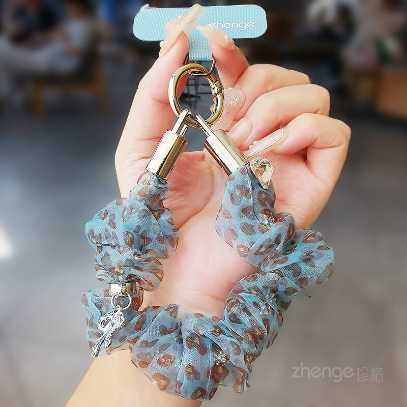Mesh leopard print phone lanyard, unique scrunchie short style with bow rhinestone pendant, fashionable anti-loss phone chain.