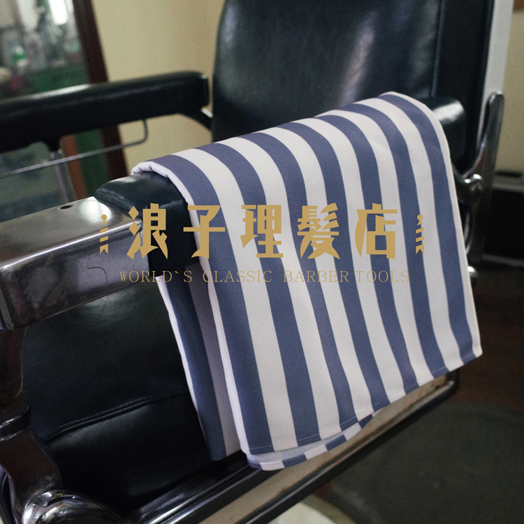 A retro-face shaving professional covered with a professional blanket.