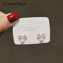 Korean simple earrings 2020 New Tide sweet bow women small imitation pearl earrings silver needle temperament