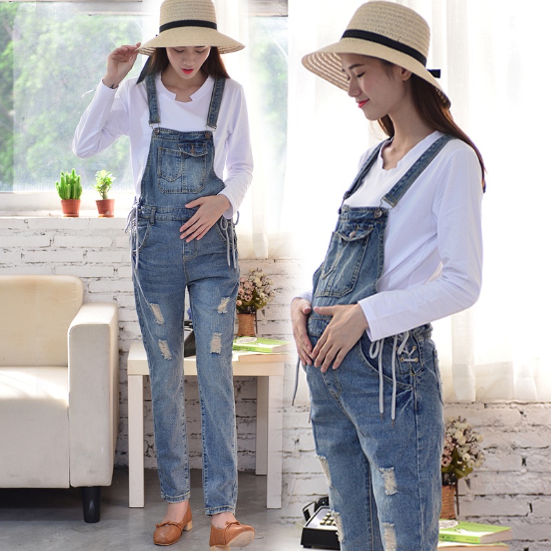 Pregnant women hold baby bag pants early autumn loose jeans spring and autumn fashion models, holes, trends, pregnancy suits