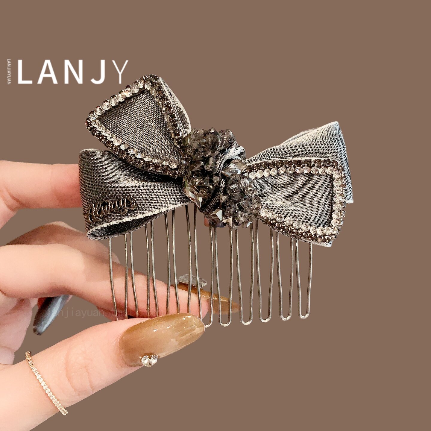 Korean-style sophisticated gray bow hair comb, fashionable and heavy-duty, for securing a bun hairstyle.