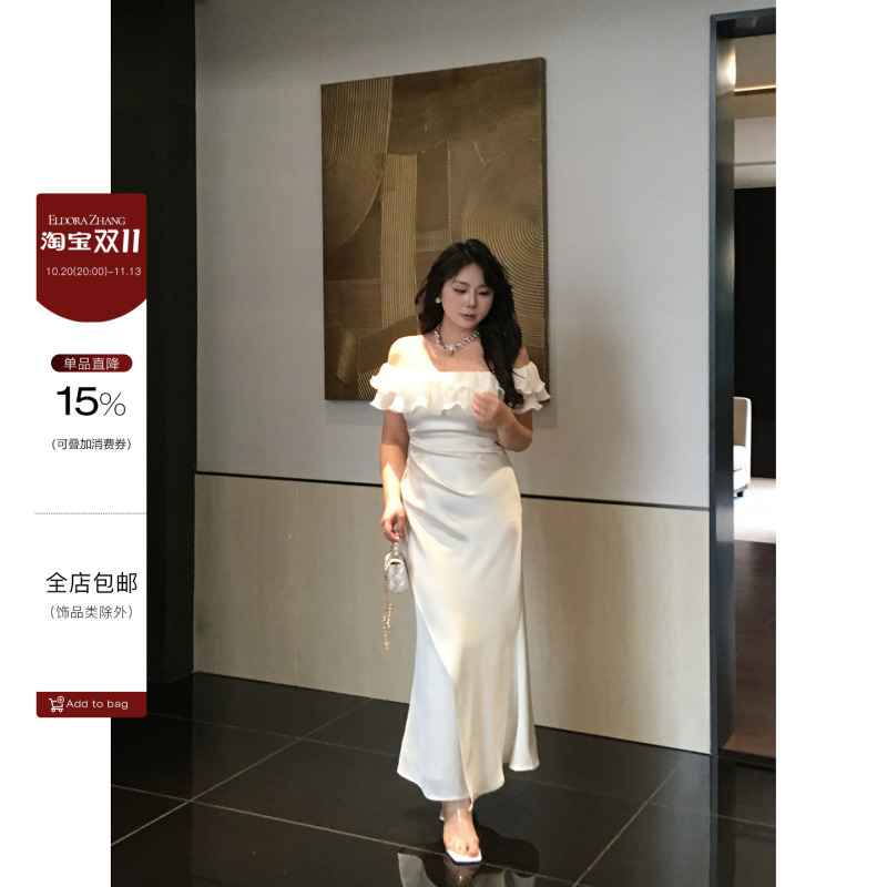 Missy, a Slightly Chubby Woman with a Plus-Size Figure, Has a Dress with a Shoulder-Length Neckline, Ruffled Edges, and a Cinched Waist in the Style of a Light Formal Dress Called "Coconut Shadow White Sand." Missy, a Slightly Chubby Woman with a Plus-Size Figure, Has a Dress with a Shoulder-Length Neckline, Ruffled Edges, and a Cinched Waist in the Style of a Light Formal Dress Called "Coconut Shadow White Sand."