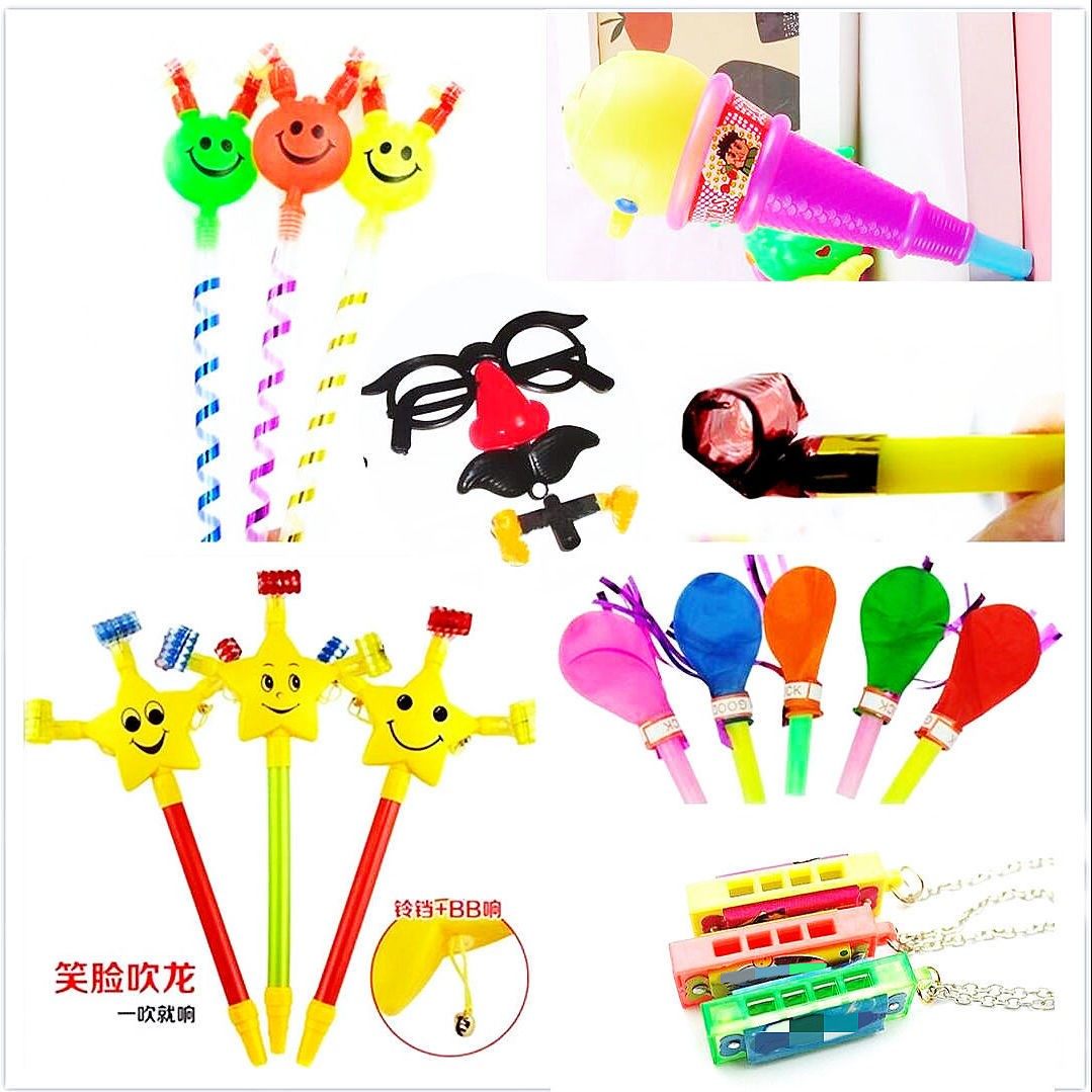 Toy children toy with mouth blown with a smile on the face and blow the whistle on the creative whistleblowing toy birthday party booing.