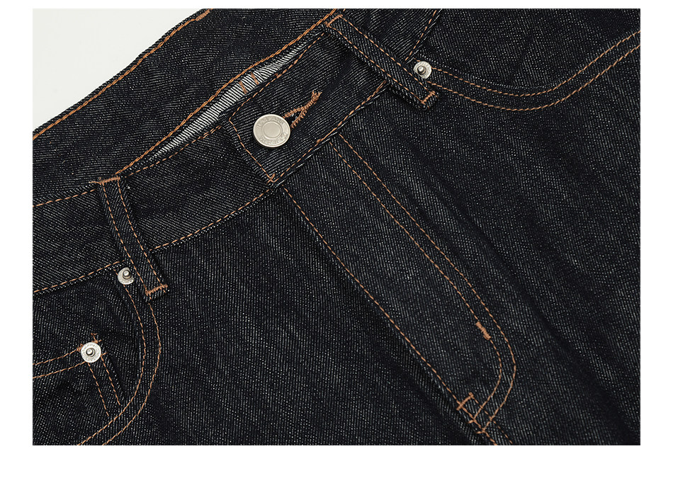 Close-up of EastLyst Vintage Jeans in dark blue, showing the waistband with orange stitching, metal rivets, a front button, and belt loops—crafted from premium raw denim for a relaxed straight leg fit.