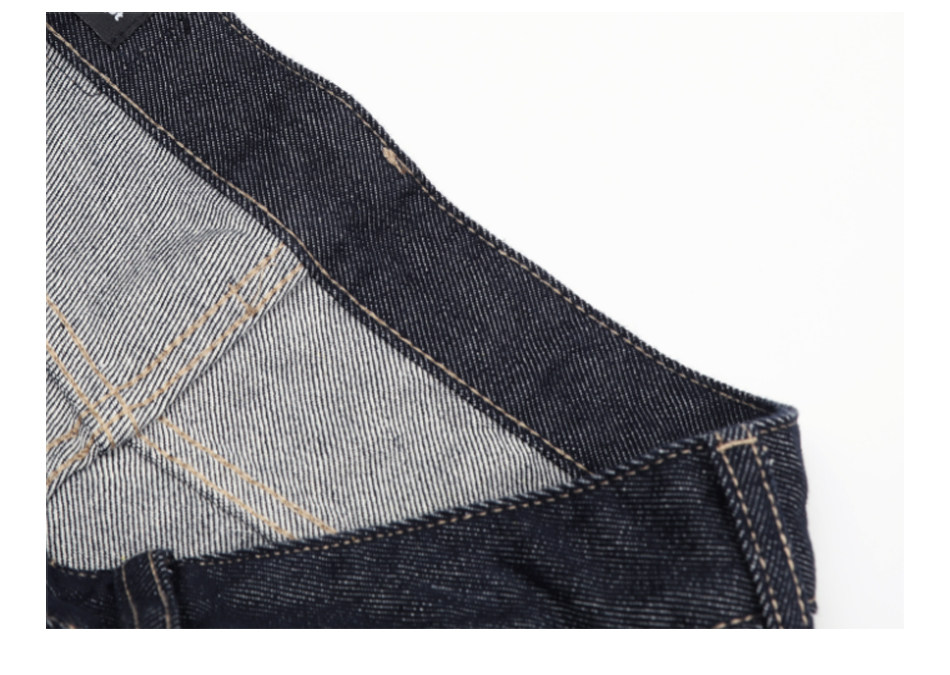 Close-up of the interior of EastLyst Classic American Straight Leg Jeans, highlighting stitching details and the texture of dark denim fabric against a white background.