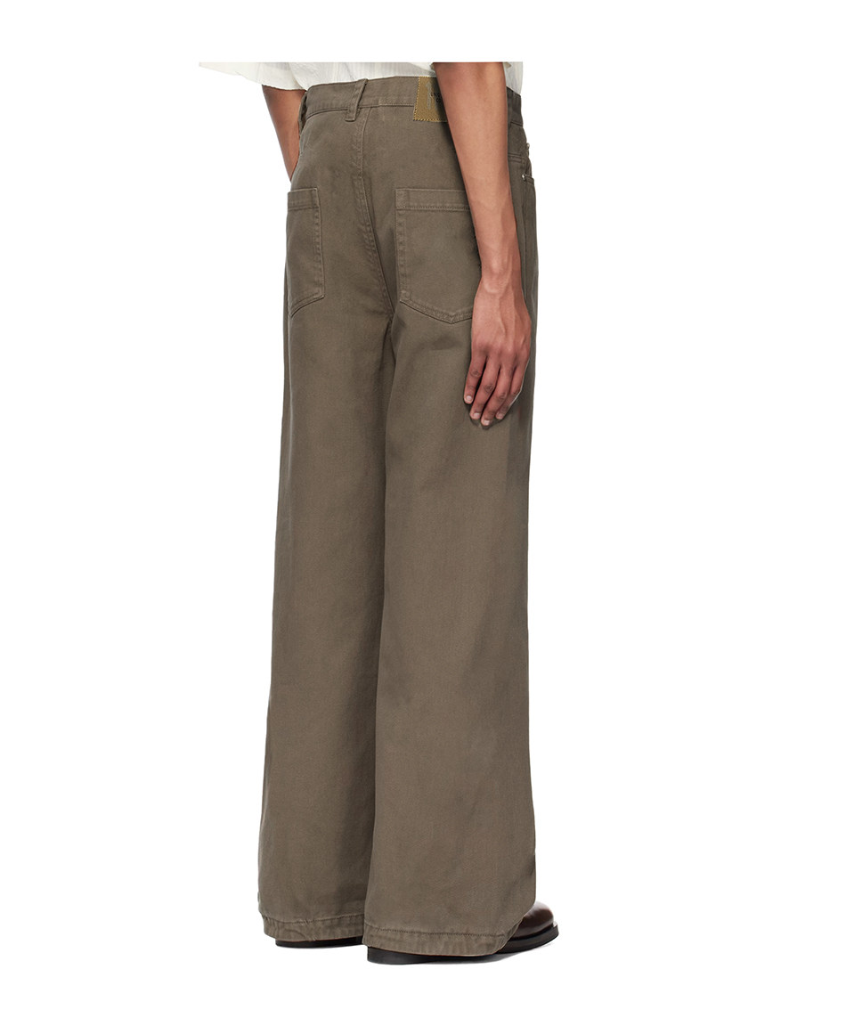 A person, seen from the back with one hand at their side, wears EastLyst Retro Distressed Flare Pants featuring a high waist and large back pockets that cover most shoes, set against a plain white background.