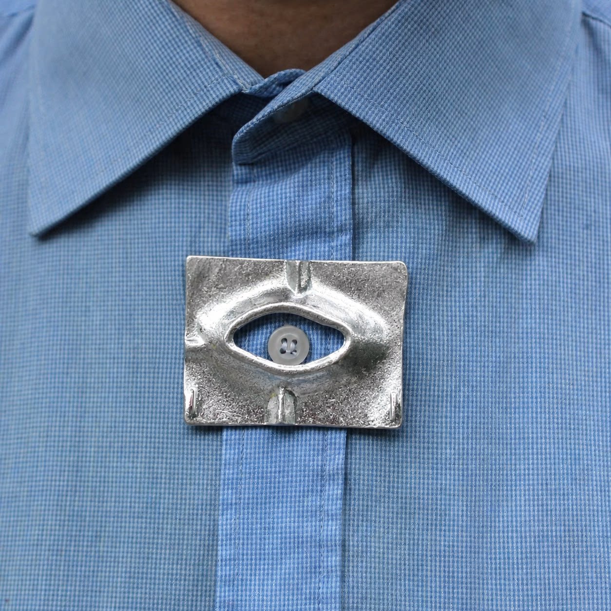 "Glancing Eye Through a Crack" - A uniquely shaped, ruffled metal brooch, perfect for niche designers and a distinctive men's shirt collar.