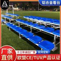 Outdoor football field aluminum alloy spectator stands. Aluminum alloy stands with blue flat chairs.