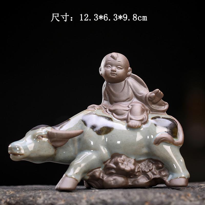 Creative Pastoral Ancient-Style Ceramic Figurine of a Boy Riding a Cow, Small Ornament for Tabletop Decoration with Plants and Flowers
