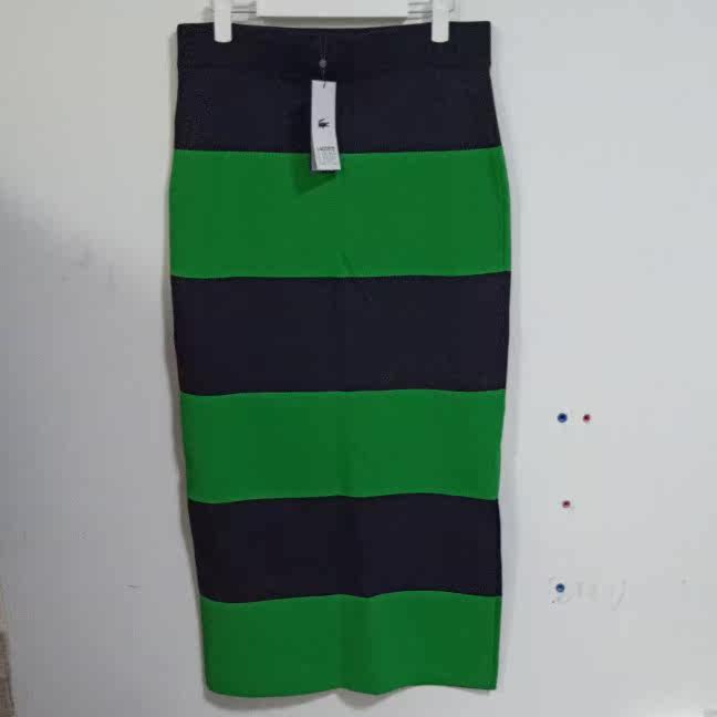 Crocodile green gnitwear with a long skirt.