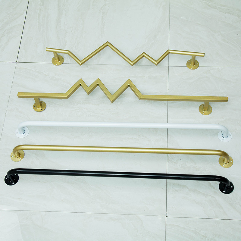 Clothing store on the wall gold wall-mounted clothes display rack shelf is hanging boys and girls clothes drying floor clothes rack