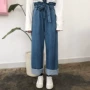 Mùa thu mới phiên bản Hàn Quốc của thắt lưng cao retro dây đeo mỏng hoang dã hoa nơ 苞 quần denim ống rộng quần áo học sinh shop quần áo nữ