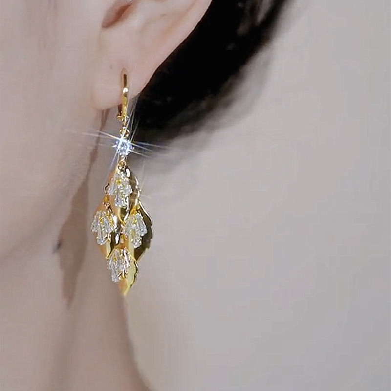 Luxury leaf tassel earrings close up detail