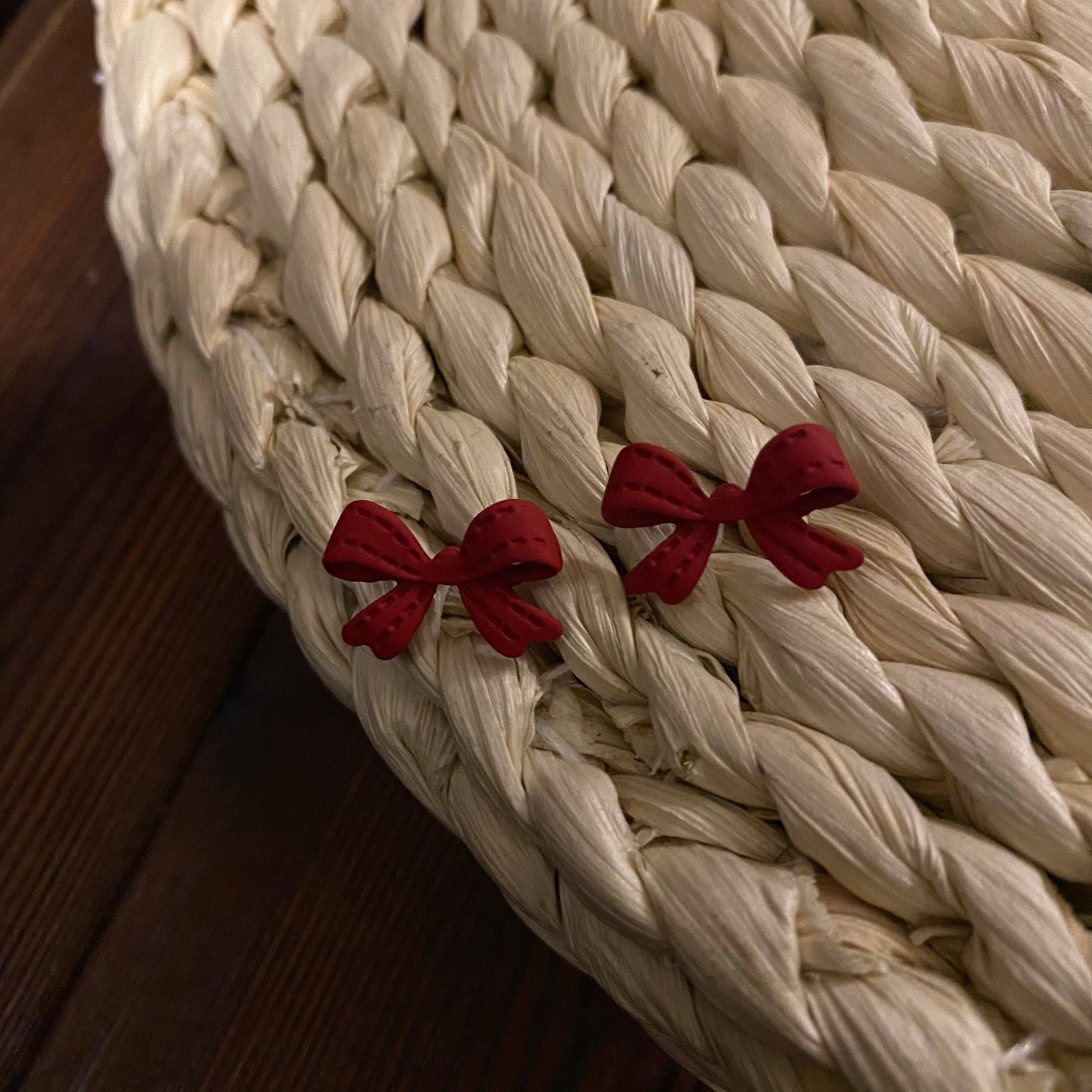 Matte mini butterfly knot ear nail S925 silver pin personality solid ear decoration ladies' Christmas wind without ear clip