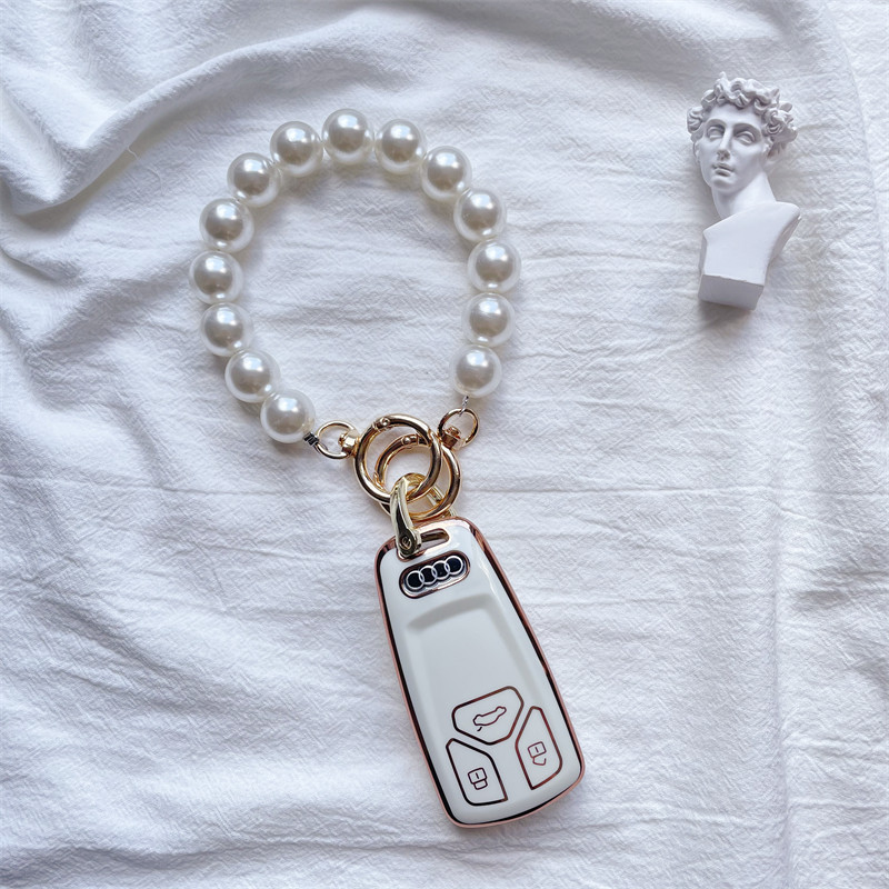 Suitable for Audi key case new A4L q5L Q7 car key case A5 buckle shell couple ornaments exquisite female high-end