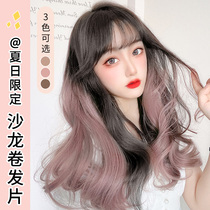 Haircraft curly hair with ear dyeing a slice of female long hair