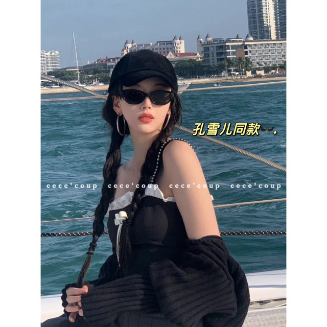 Showing face with little black cat-eye sunglasses sunglasses