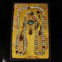 Antiques and miscellaneous collections. A collection of white cats eye beads with an old lacquer box and 108 beads. A rosary pendant.