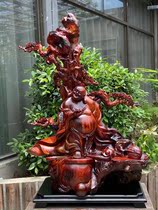 The cliff root carving the big Holy root bouldering the stone Buddha statue wood carving Ebony Guan Gong Sheng Monkey King fighting against the Buddha statue