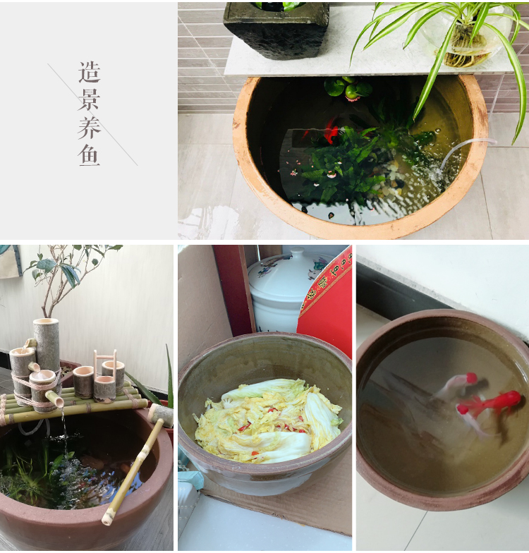 A large old - fashioned tank earthenware water lily cylinder garden plant landscape is suing fish turtles goldfish lotus home