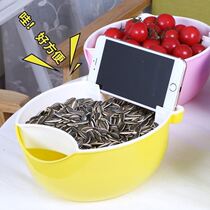 Lazy people chase drama to eat melon seeds dried fruit plate with mobile phone bracket double melon seeds plate to eat desktop garbage can home