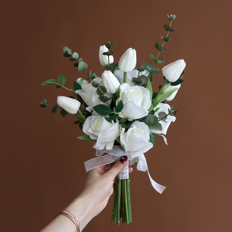 The leader holds the flower hand holding the simulation bouquet moisturizing rose tulip bride's wedding photography prop swing piece