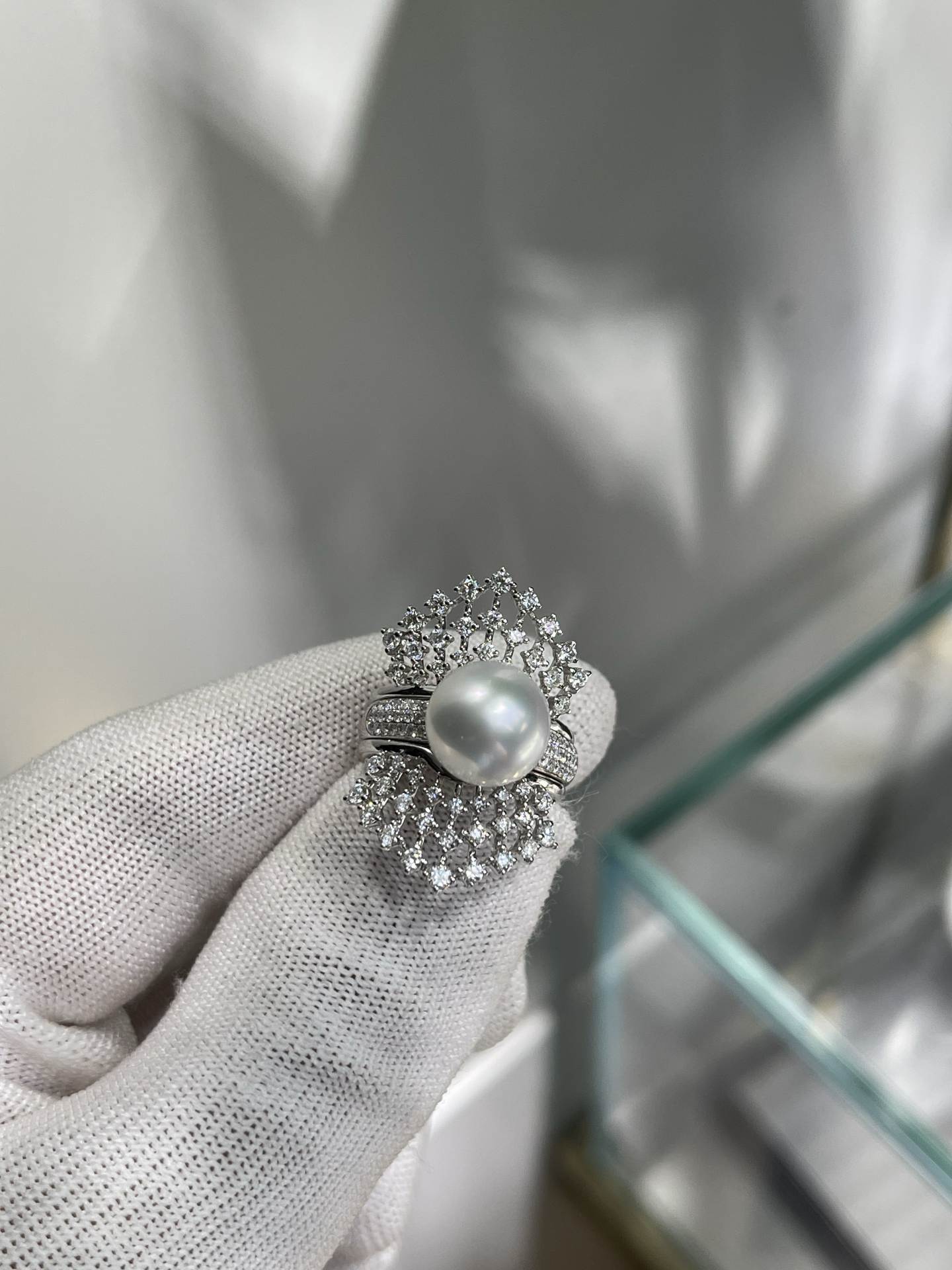 A two-wear ring that can be worn daily or for flamboyance. 10.64mm Australian white set with 18k natural diamonds. Dazzling.
