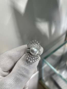 A two-wear ring that can be worn daily or for flamboyance. 10.64mm australian white set with 18k natural diamonds. dazzling.