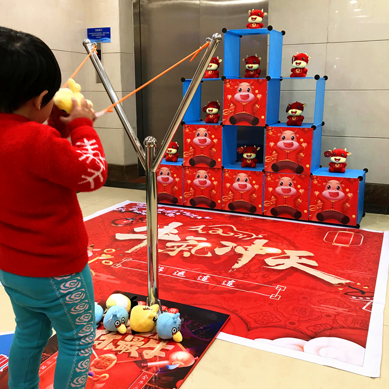 Live version of angry slingshot catapult football Year of the Ox toy Square Amusement Company promotional warm-up props