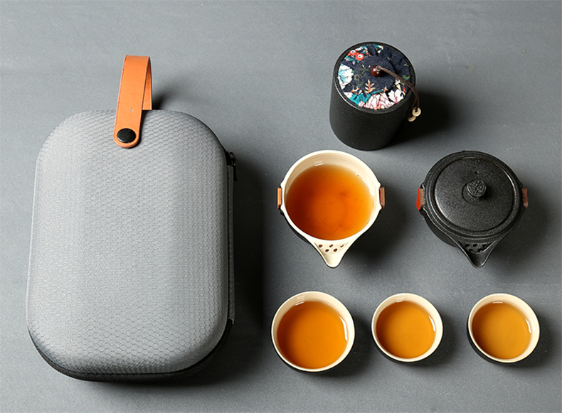 Black pottery travel kung fu tea set to crack a pot of four cups of small portable bag outside Japanese mini household contracted