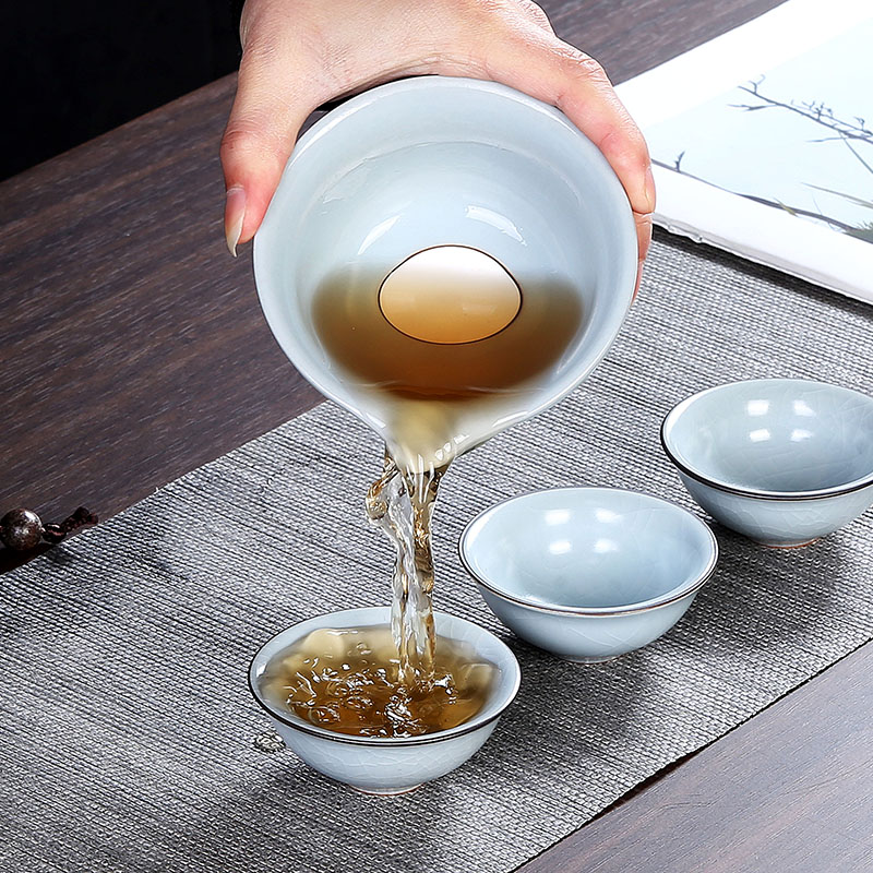 Crack cup against a pot of three cups of hot ceramics glass portable travel kung fu tea set contracted