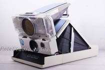 Polaroid Polaroid white SONAR autofocus pat on the SX70 power supply behind the EVO display