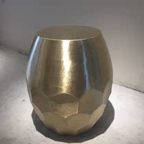Stainless steel hexagonal brass sitting on the side of a few corners of the high-end luxury house living room with a prismatic sitting stool