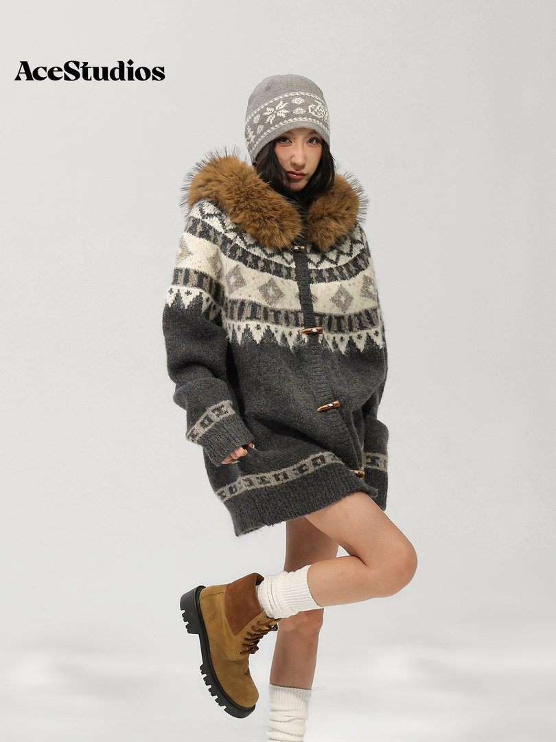 Model wearing a warm patterned knit sweater with fur collar, beanie, socks, and brown boots