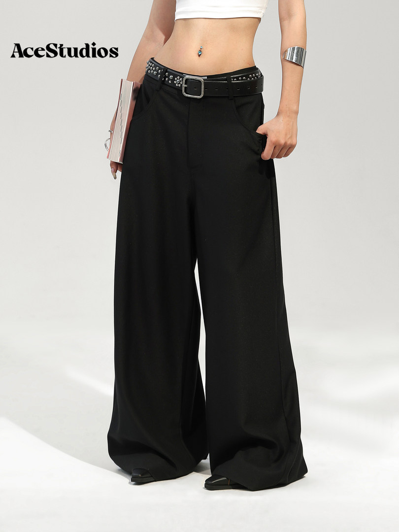 Model wearing black wide-leg pants with a belt