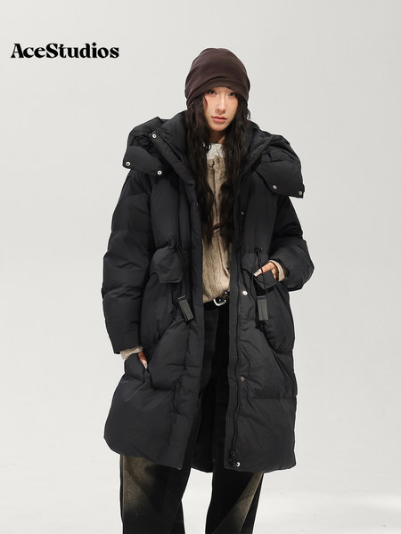 Model wearing a long black hooded puffer coat